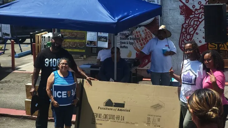 Fair Oaks Burger Reopening - Furniture raffle winner poses for pictures